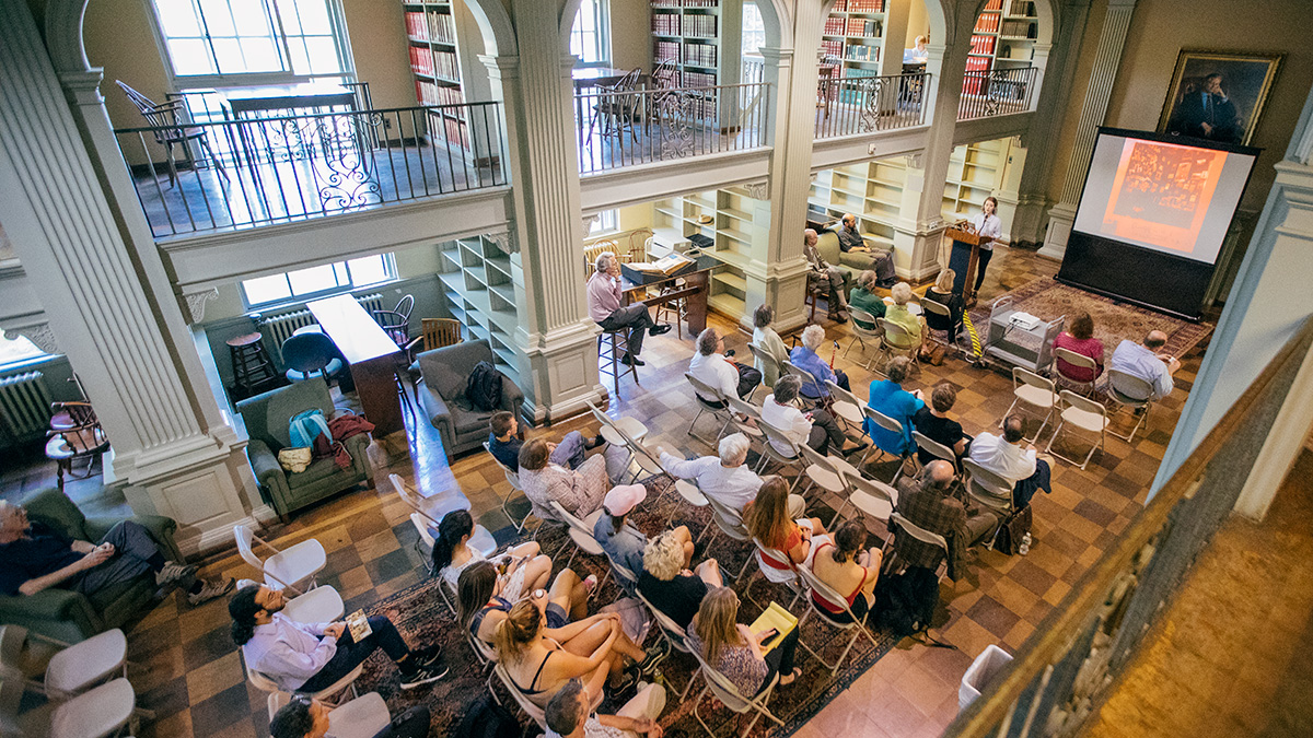 Patrons looking at a projector screen in the Current Periodicals Room