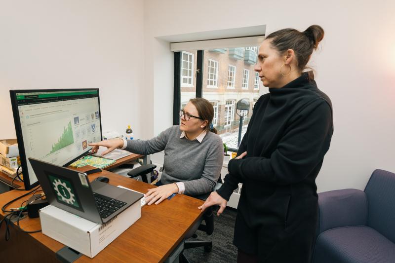 Feldberg Library librarians Jentry Campbell left and Amelia Looby right look at a computer screen display Patent Lens information