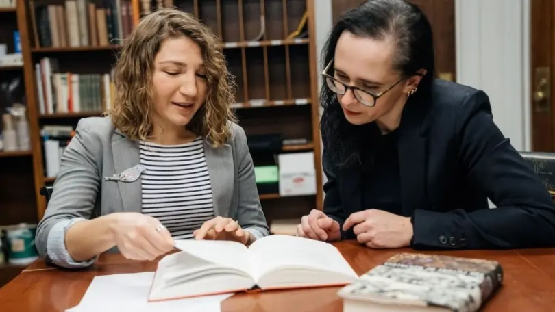 German studies professor Yuliya Komska, right, works with Tetiana Savchynska, Guarini ’18, who has translated numerous English texts into Ukrainian under contract with the Old Lion Publishing House, one of the biggest Ukrainian publishers.