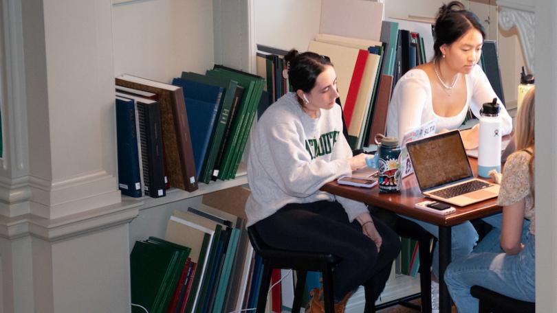 three students study on a tall table in the East Reading Room
