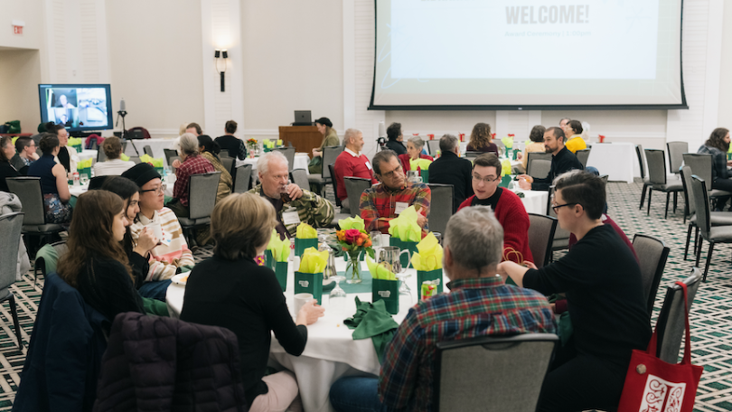 library staff sit and talk during the luncheon