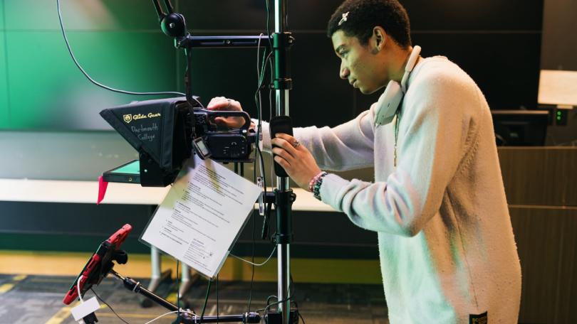 a student works with video recording equipment in the innovation lab