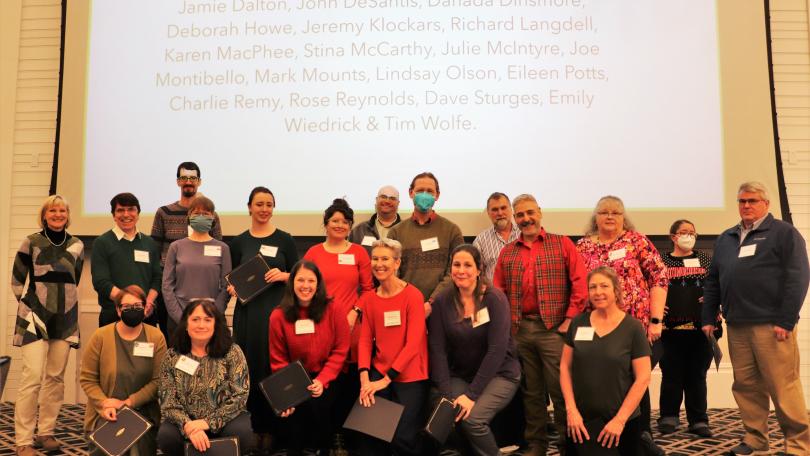 ACS group posing at the 2022 holiday party awards ceremony