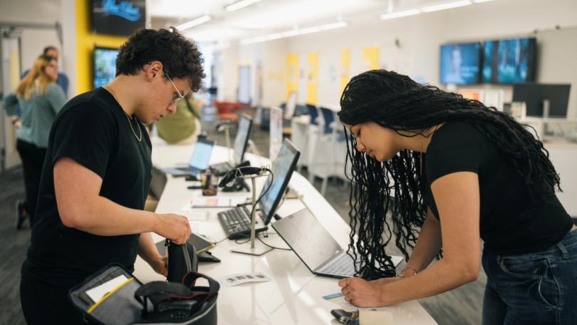 A student checking out equipment from the Jones Media Center
