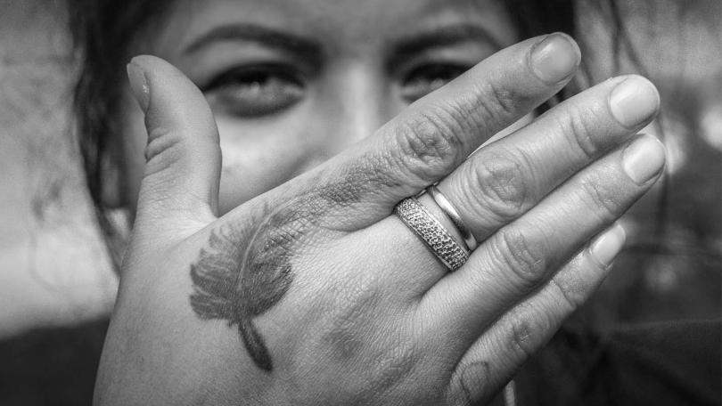 Woman with tattoed hand in front of face. Photo by Jorge Carlos Alvarez Diaz. From the book 'Hands that Speak: Voices from the Upper Valley Dairy Farms," by the author Maria Clara De Greiff.