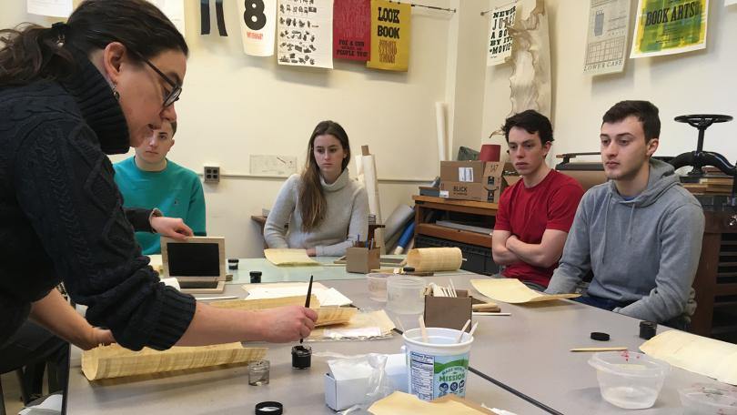 students around the table with parchment and papyrus lesson