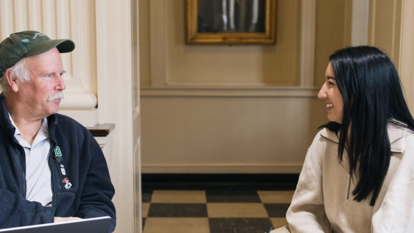 two people chat in Reiss Hall