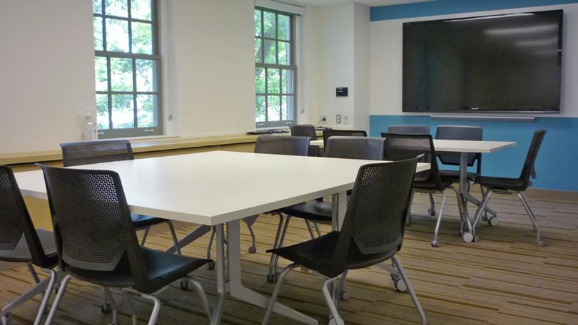 A conference room with tables and chairs