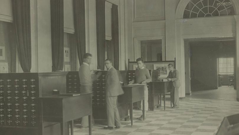 Dartmouth students looking at the Baker-Berry catalog in 1930.