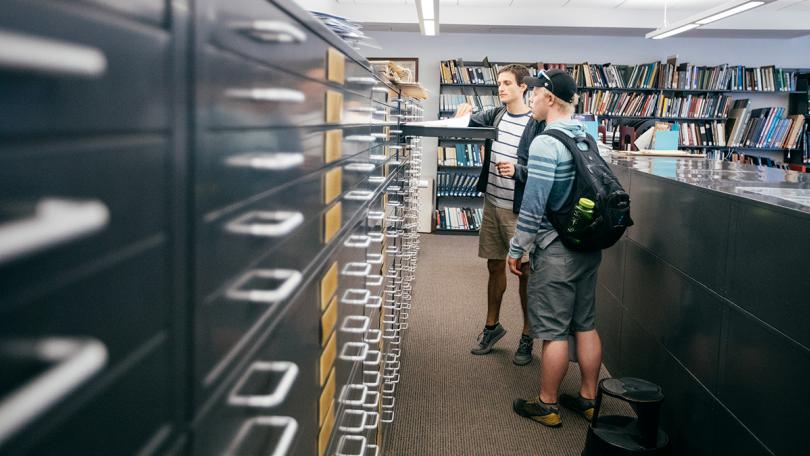 Students examine maps in the Evans Map Room at the Dartmouth Library