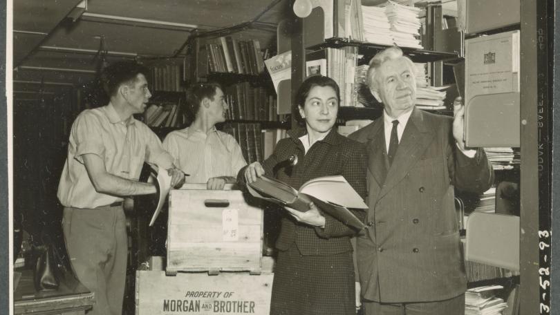 two movers help Evelyn and Vilhjalmur Stefansson unpack their vast polar library at Dartmouth