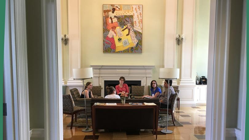 Group of people at a table with painting