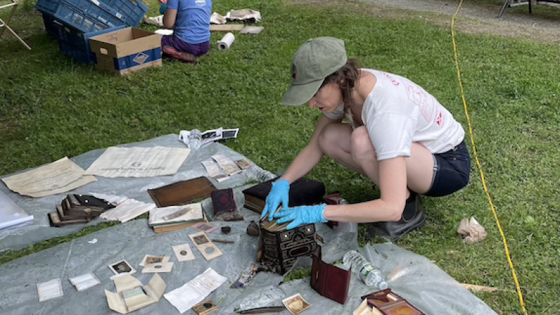 Lizzie and Jamie work on the ground to salvage archival artifacts damaged by the Vermont flood 2023