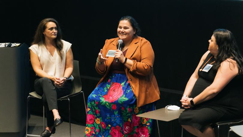 speaking on stage from left: Jennifer O'Neal, Confederated Tribes of Grand Ronde, Veronica Pipestem, Osage/Otoe Missouria, and Jami Powell, Osage