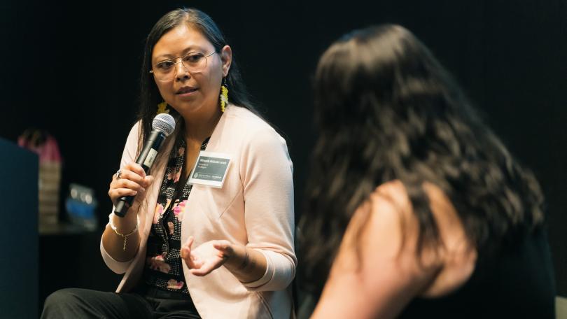 Miranda Belarde-Lewis talks on stage with Jami Powell as part of the Advancing Pathways Colloquium 