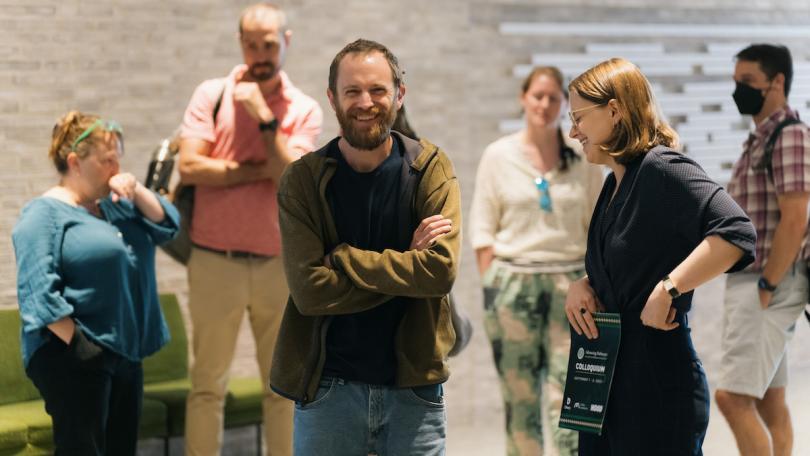 people smile and network with each other during a break at the Advancing Pathways Colloquium