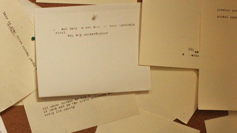 typed notes hung on wall
