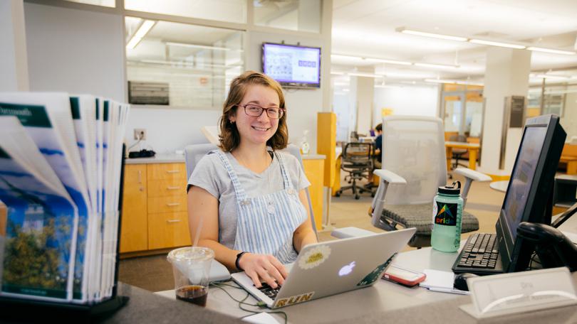 A student worker at front desk of library