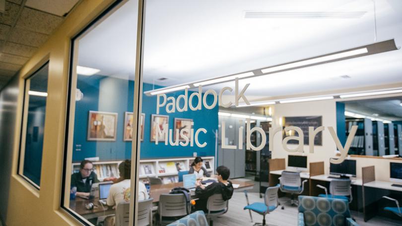 Writing on window says Paddock Library and students studying