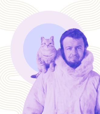 cat riding on shoulder of man in arctic parka