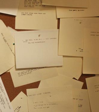 typed notes hung on wall