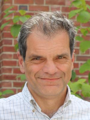 Matthew M. Benzing in front of brick wall