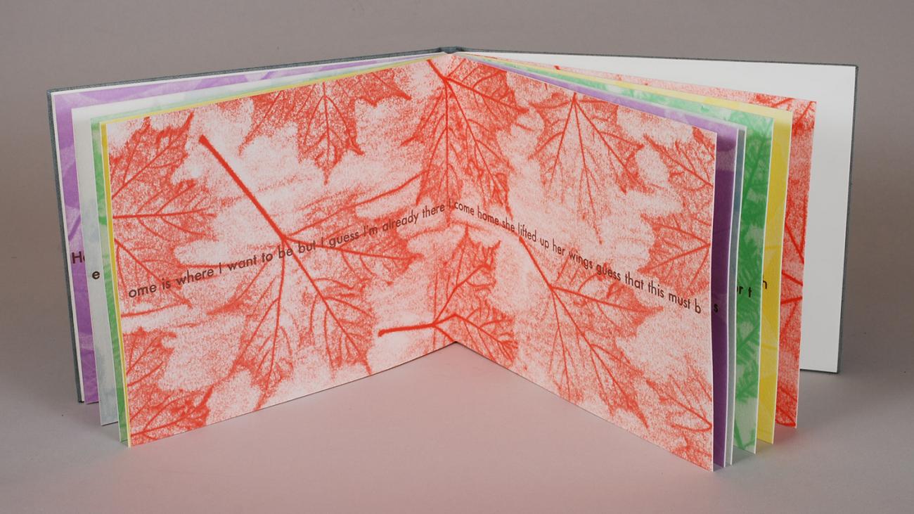 artist book with printed red leaves and song lyrics