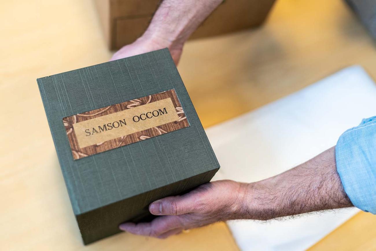 Peter Carini, College Archivist holds Occom papers presentation box.