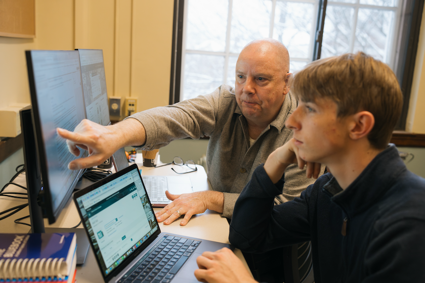 Wendel Cox assists a student with searching library databases