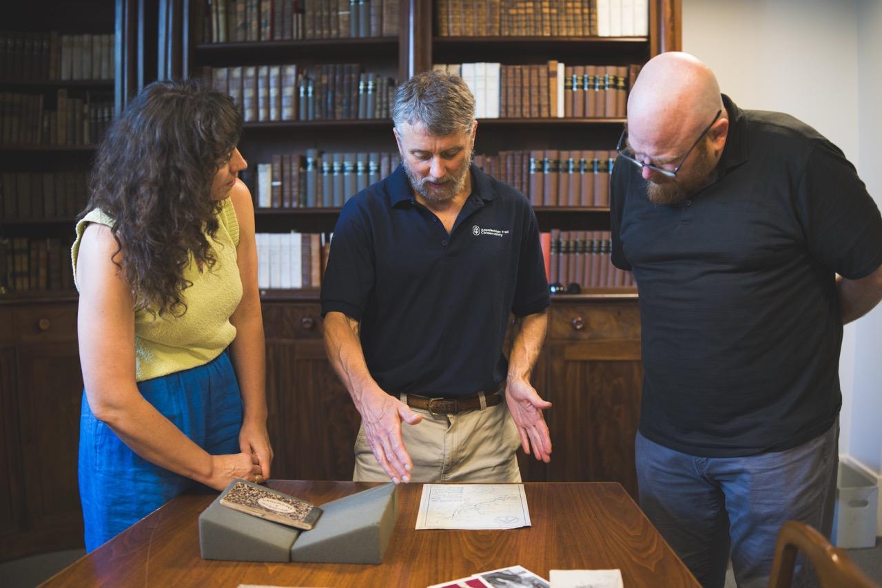 from left Leonee Derr, Hawk Metheny, and Morgan Swan look at items from the MacKaye Family Papers