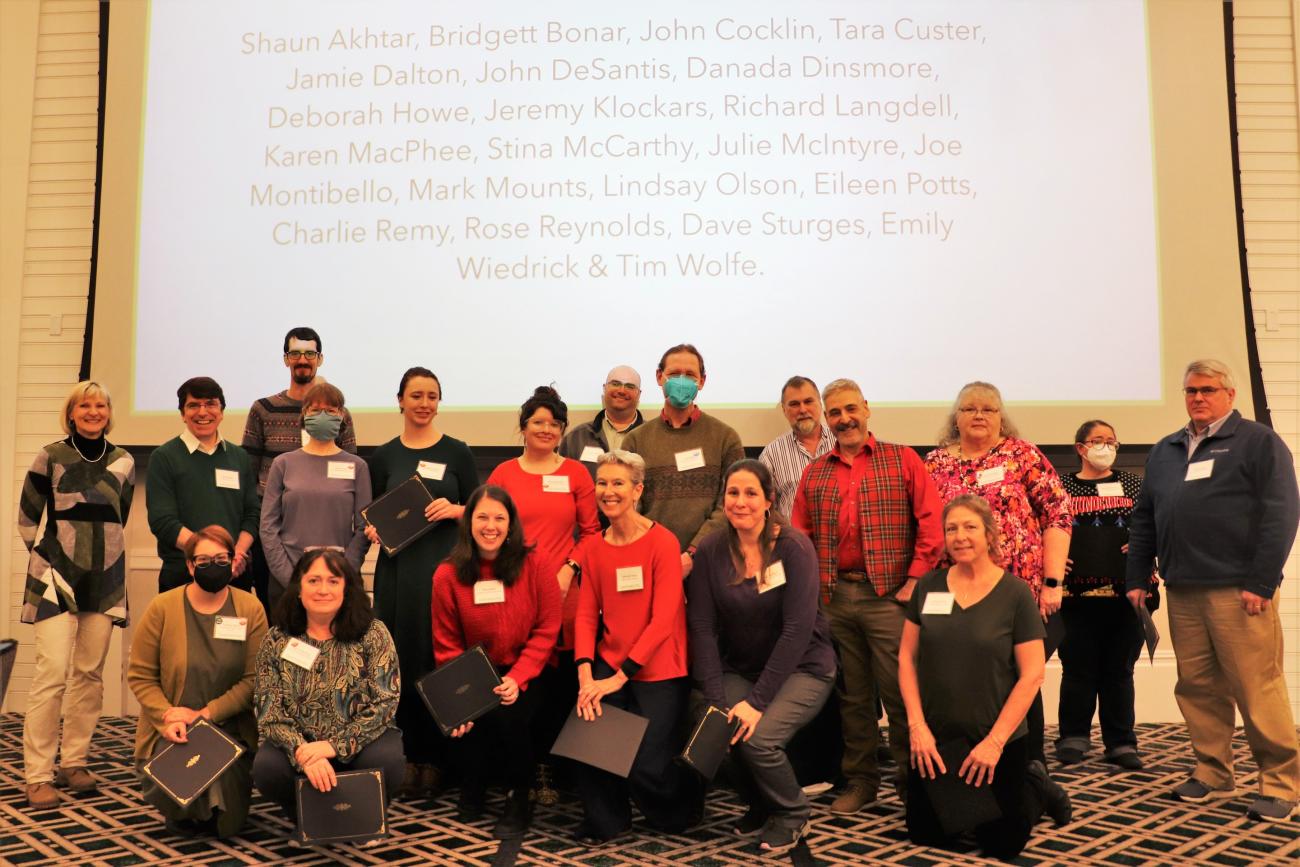 ACS group posing at the 2022 holiday party awards ceremony