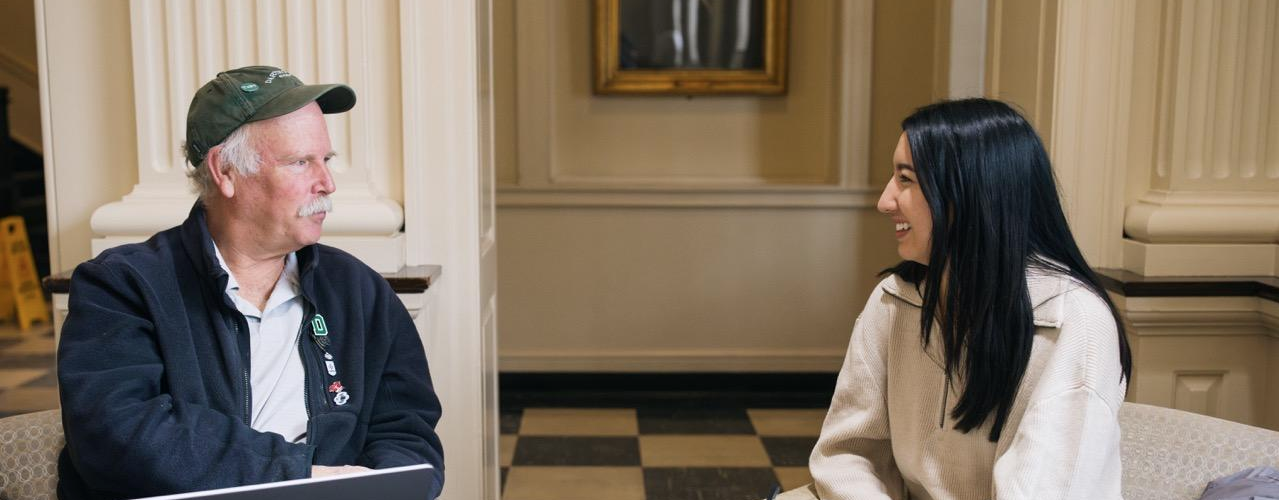 two people chat in Reiss Hall