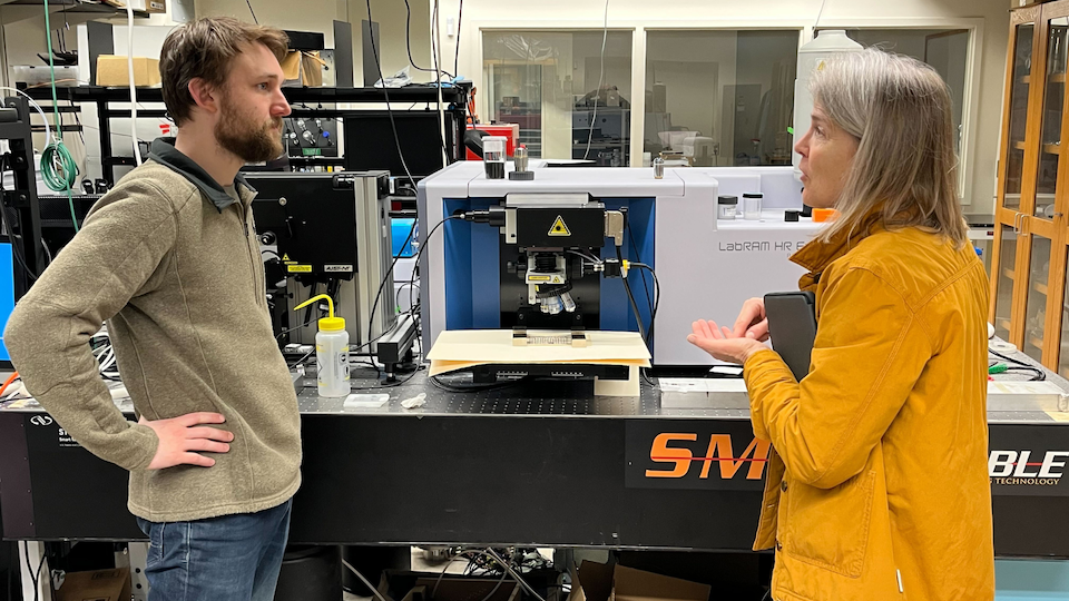 a Burke Lab technician and professor Jenny Lynn discuss results of the Raman spectrocopy