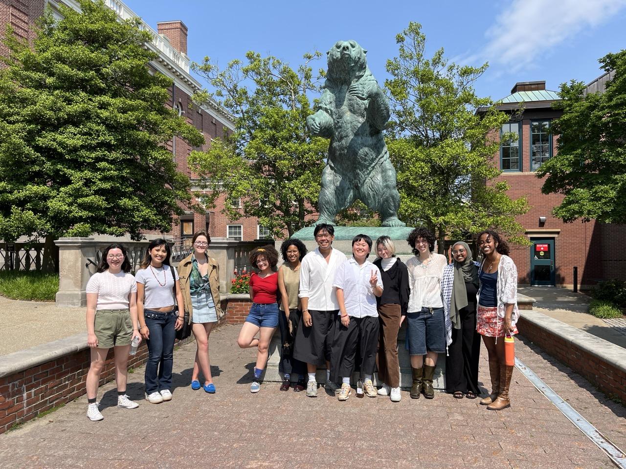 summer student researchers from Brown University and Dartmouth smile at the camera in front of Brown's mascot bear at Brown University