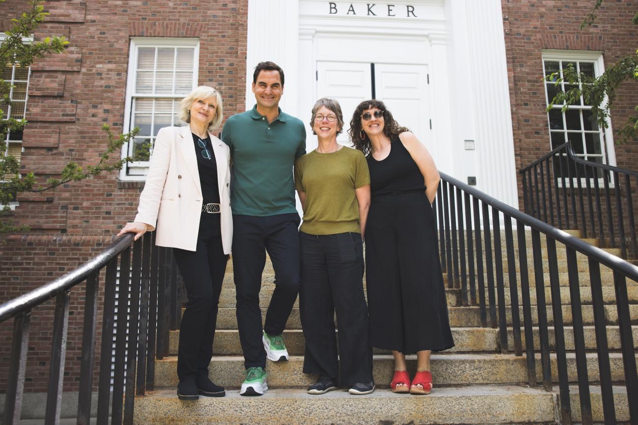 from left Dean of Libraries Susanne Mehrer, Roger Federer, Jennifer Taxman, and Leonee Ariel Derr stand in front of the Baker Library entryway