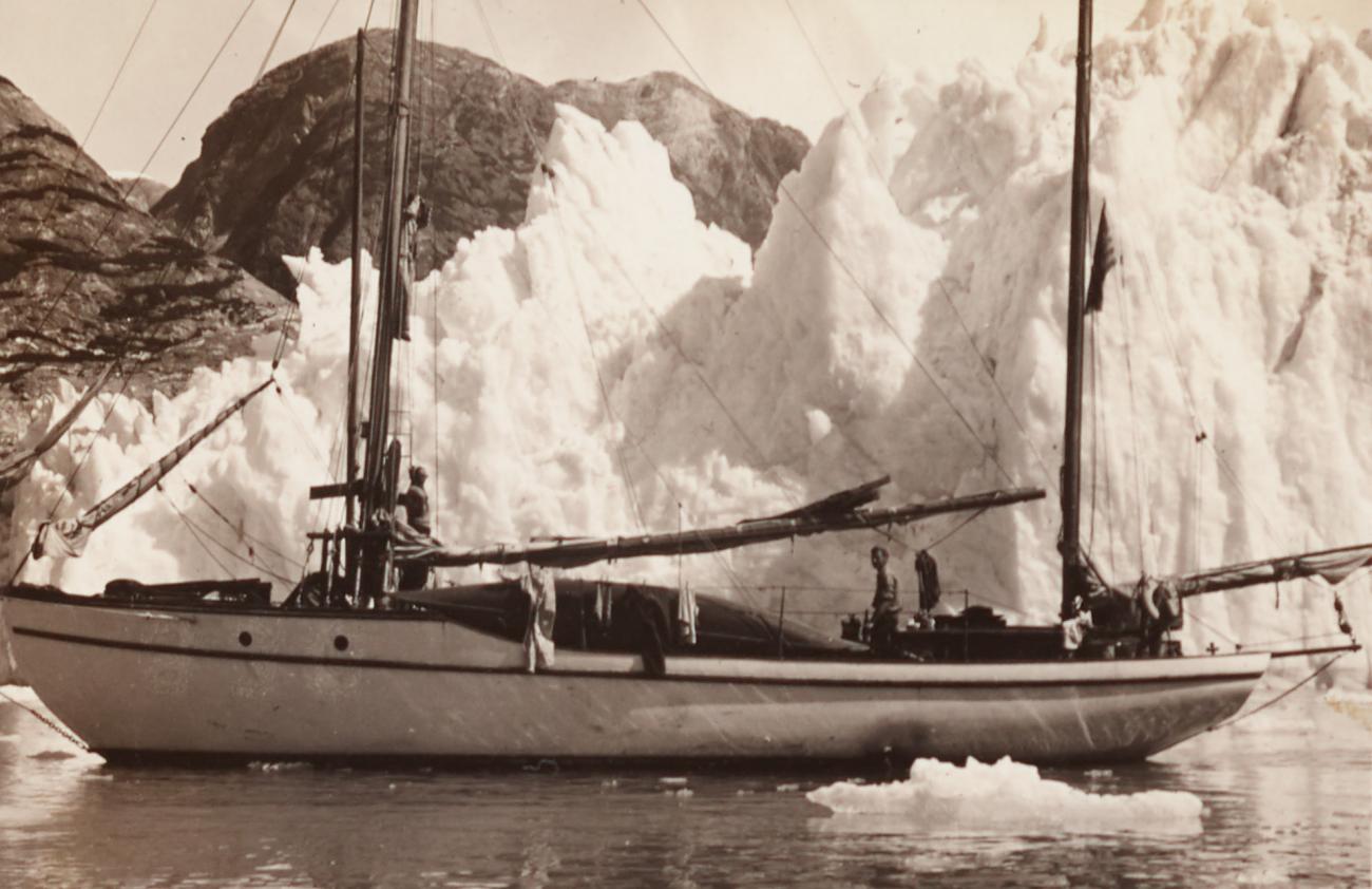 two men on ship near ice with hills in background, taken from page 17r of the album of photographs