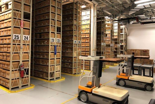 inside of the records warehouse rows of shelves with boxes and two lifts