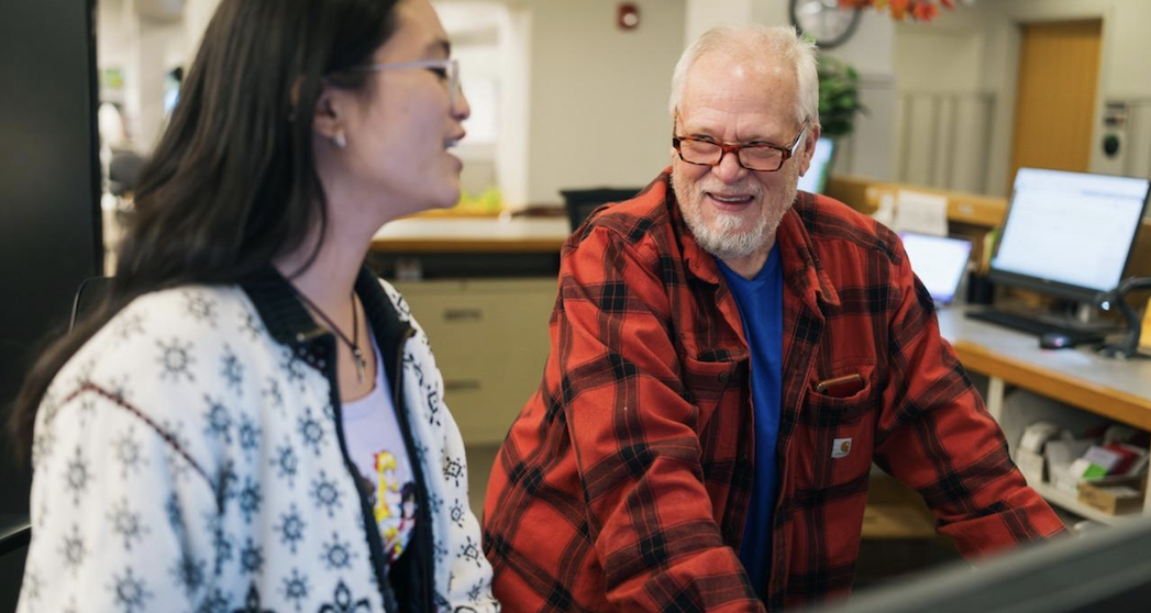 two people talking at the berry library circulation desk