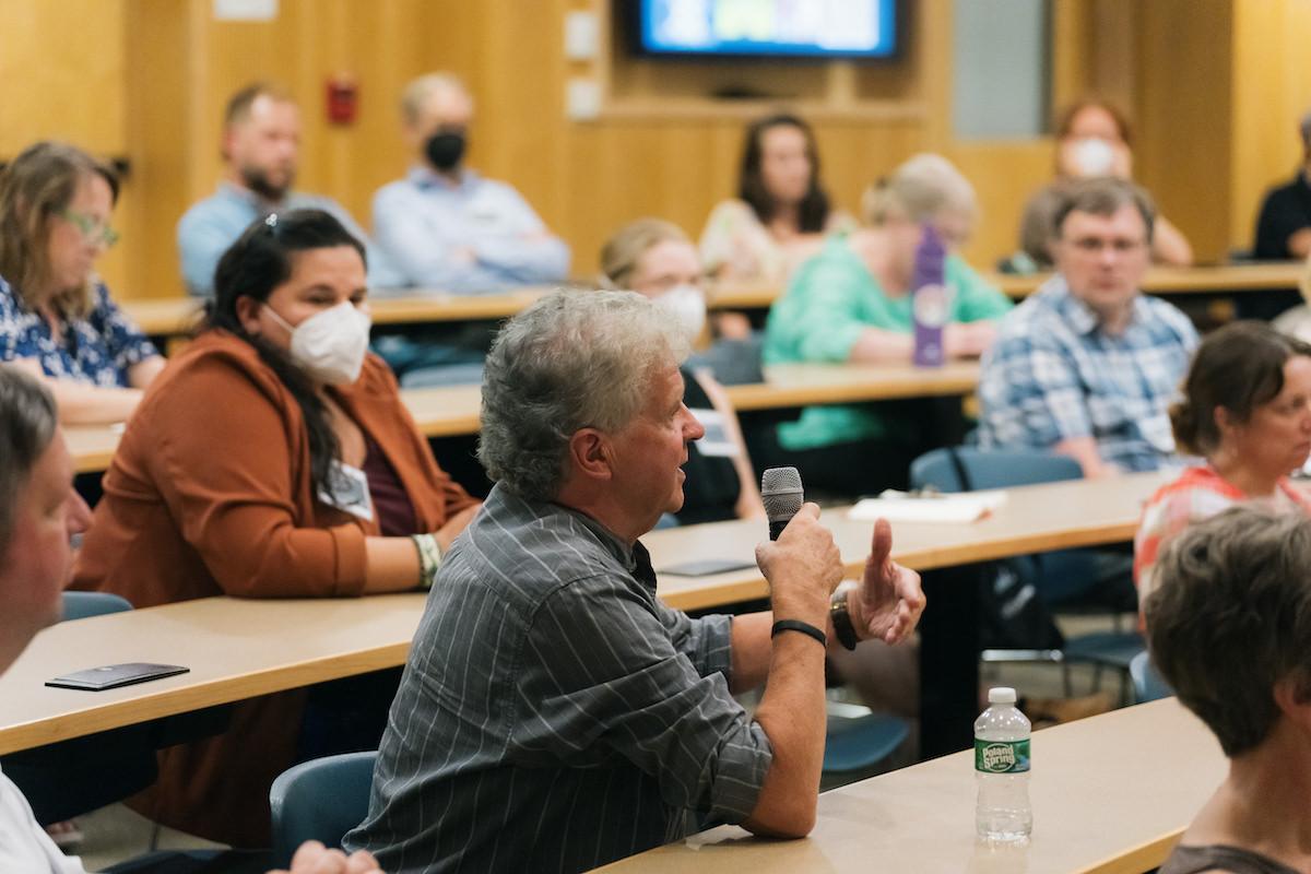 Advancing pathways colloquium attendees listen to a question being asked of speaker Mike Kelly from Amherst College
