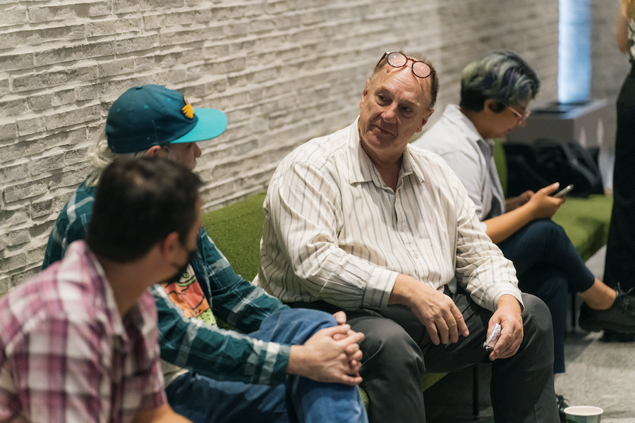 John R. Stomberg talks with two Dartmouth Libraries staff members