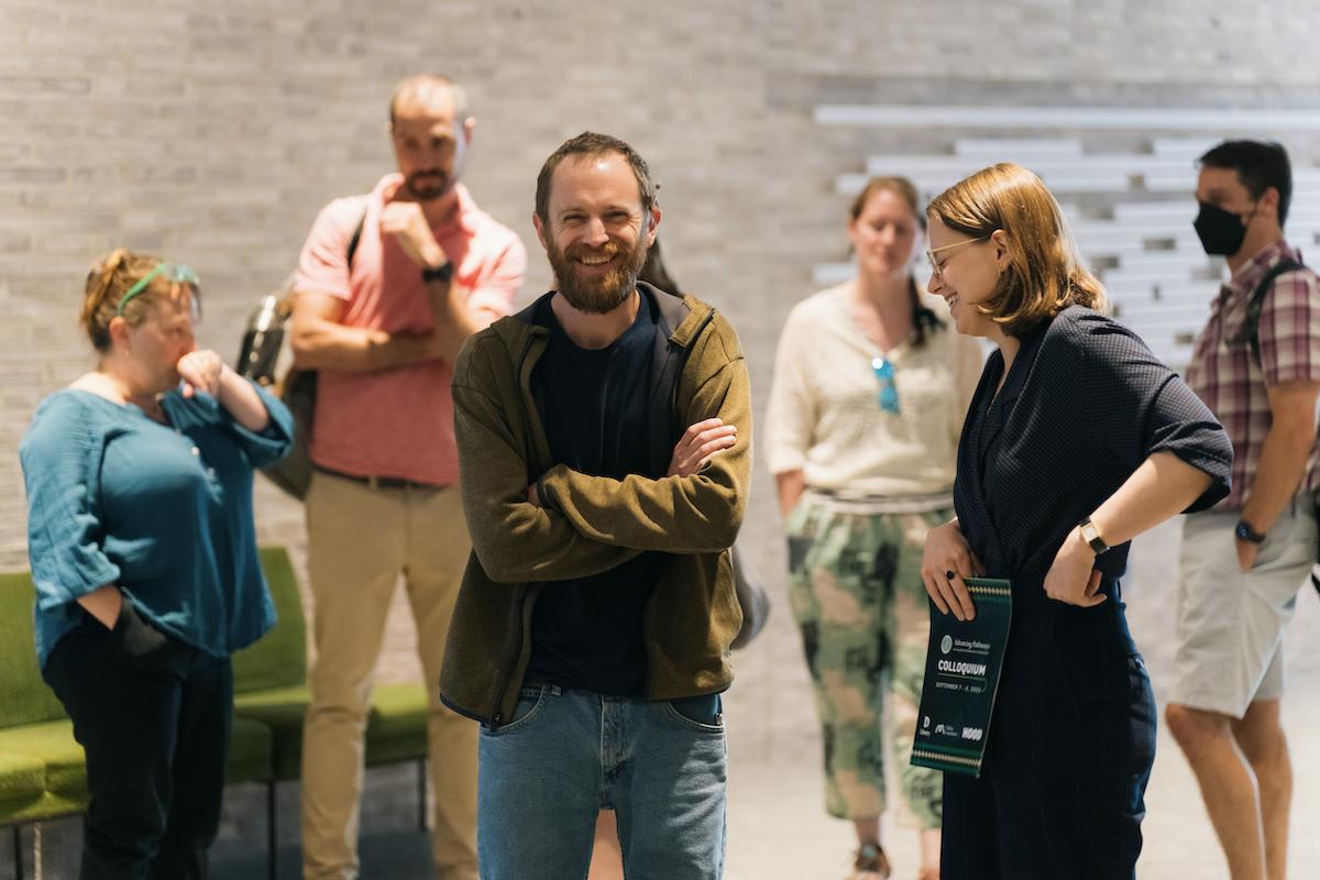 people smile and network with each other during a break at the Advancing Pathways Colloquium