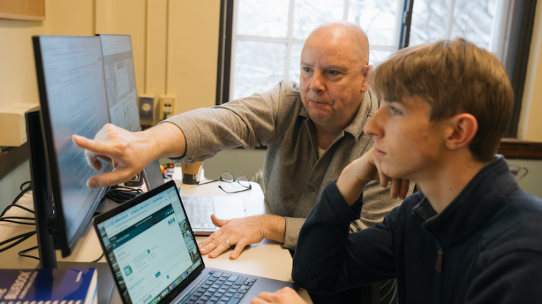 Wendel Cox assists a student with searching library databases