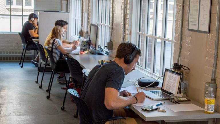 Students study in the Baker stacks on level 3