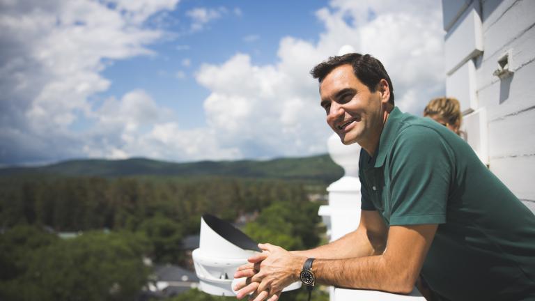 Roger Federer smiles as he looks across the valley atop Baker Bell Tower