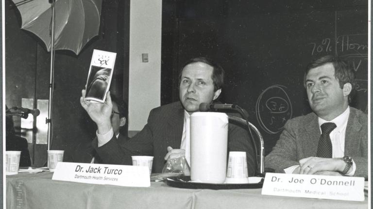 Dr Jack Turco left holds a safe sex pamphlet at a Dartmouth talk in 1980s with Dr Joe O'Donnell
