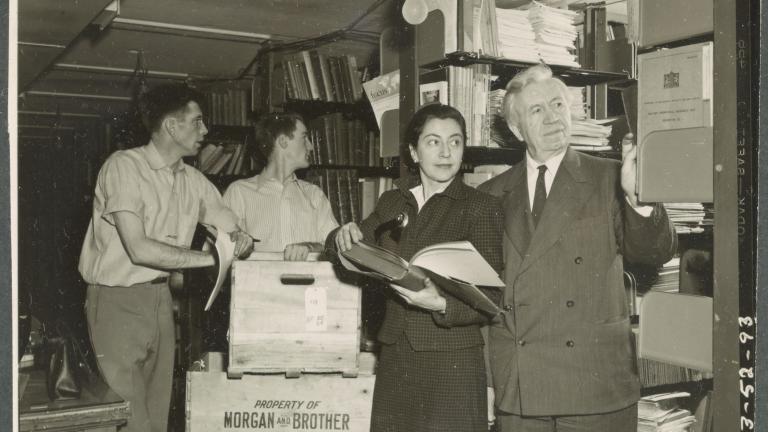 two movers help Evelyn and Vilhjalmur Stefansson unpack their vast polar library at Dartmouth