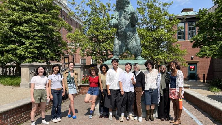 summer student researchers from Brown University and Dartmouth smile at the camera in front of Brown's mascot bear at Brown University