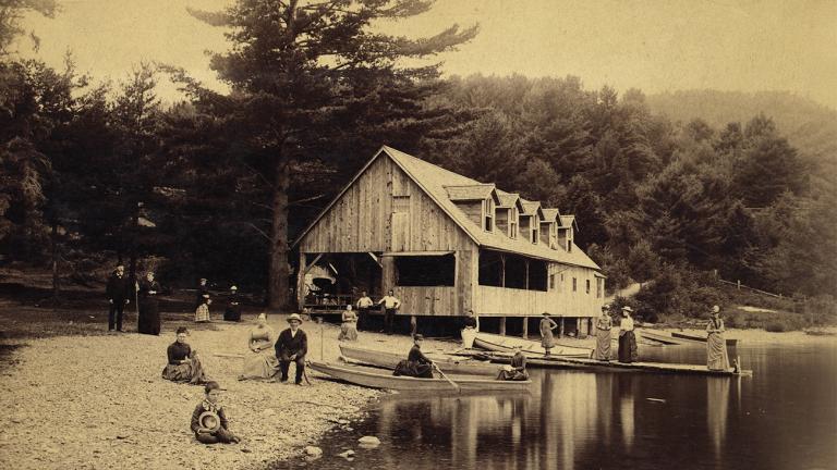 sepia image of a boat house by the water side 